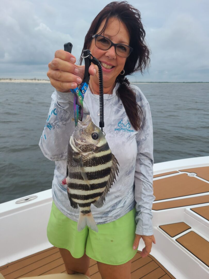 A woman holding a beautiful fish
