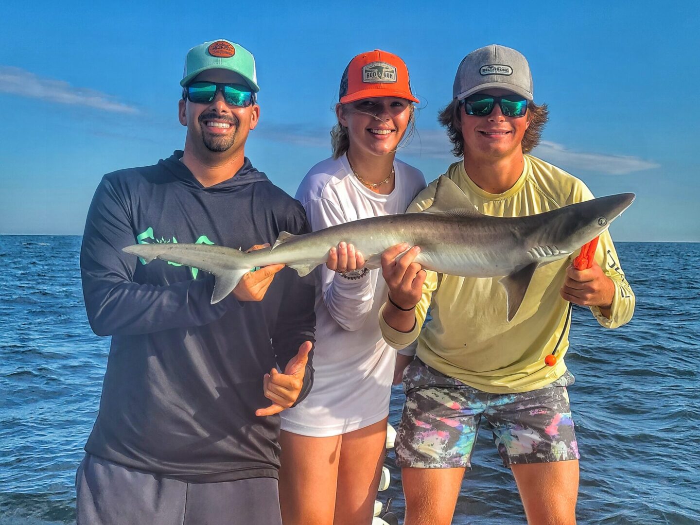 A group of people holding a long shark